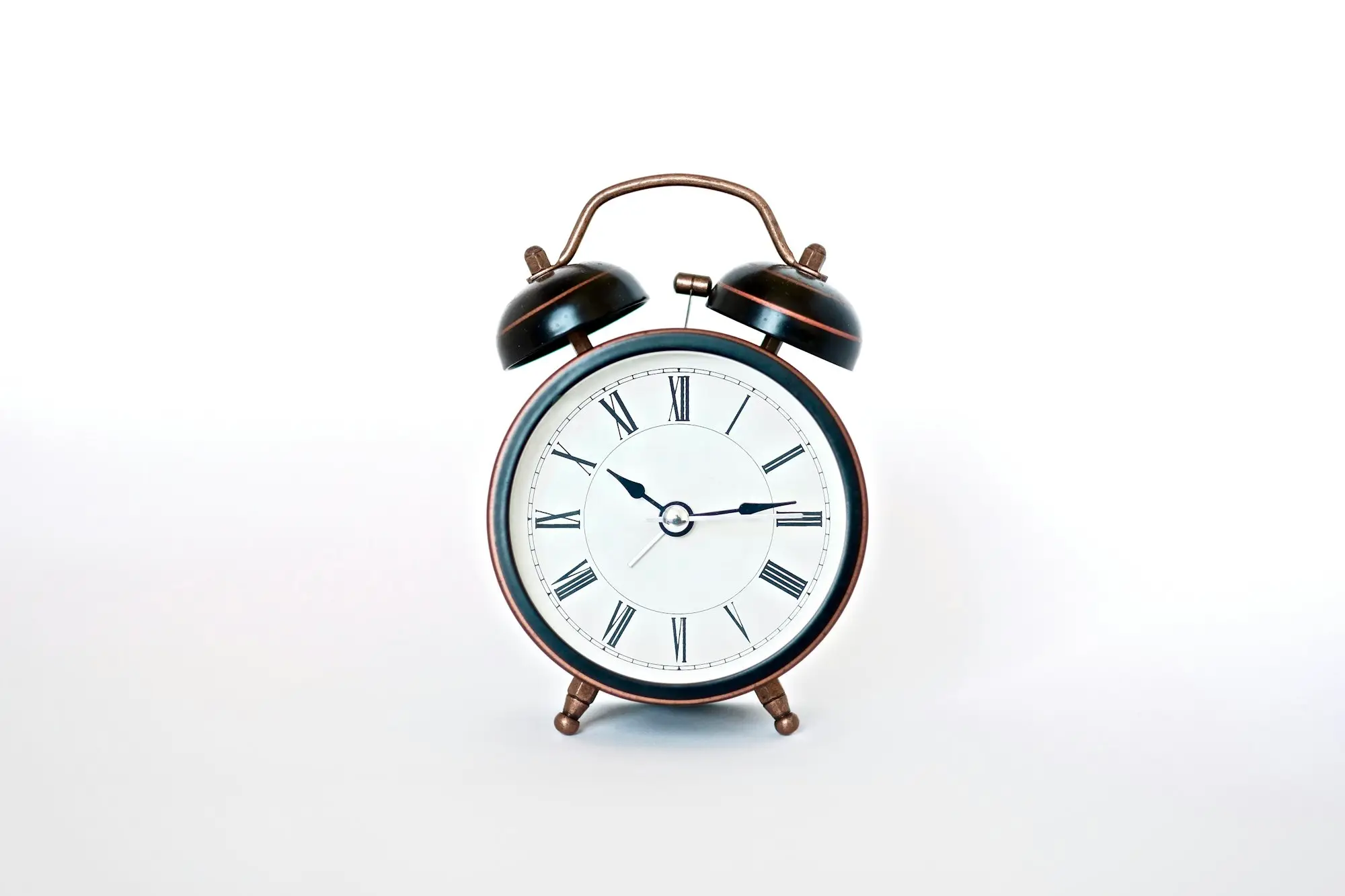 Round black and white alarm clock marking a deadline