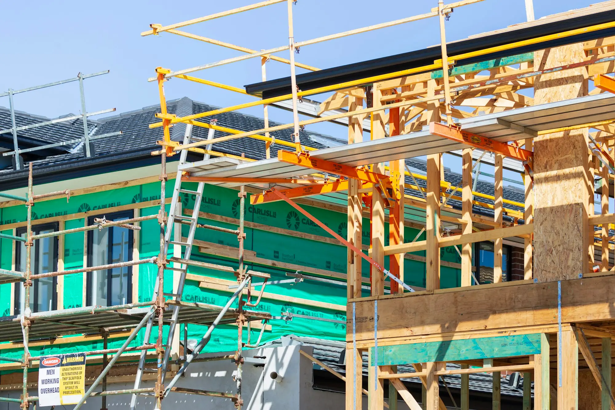 House under construction with scaffolding on the roof