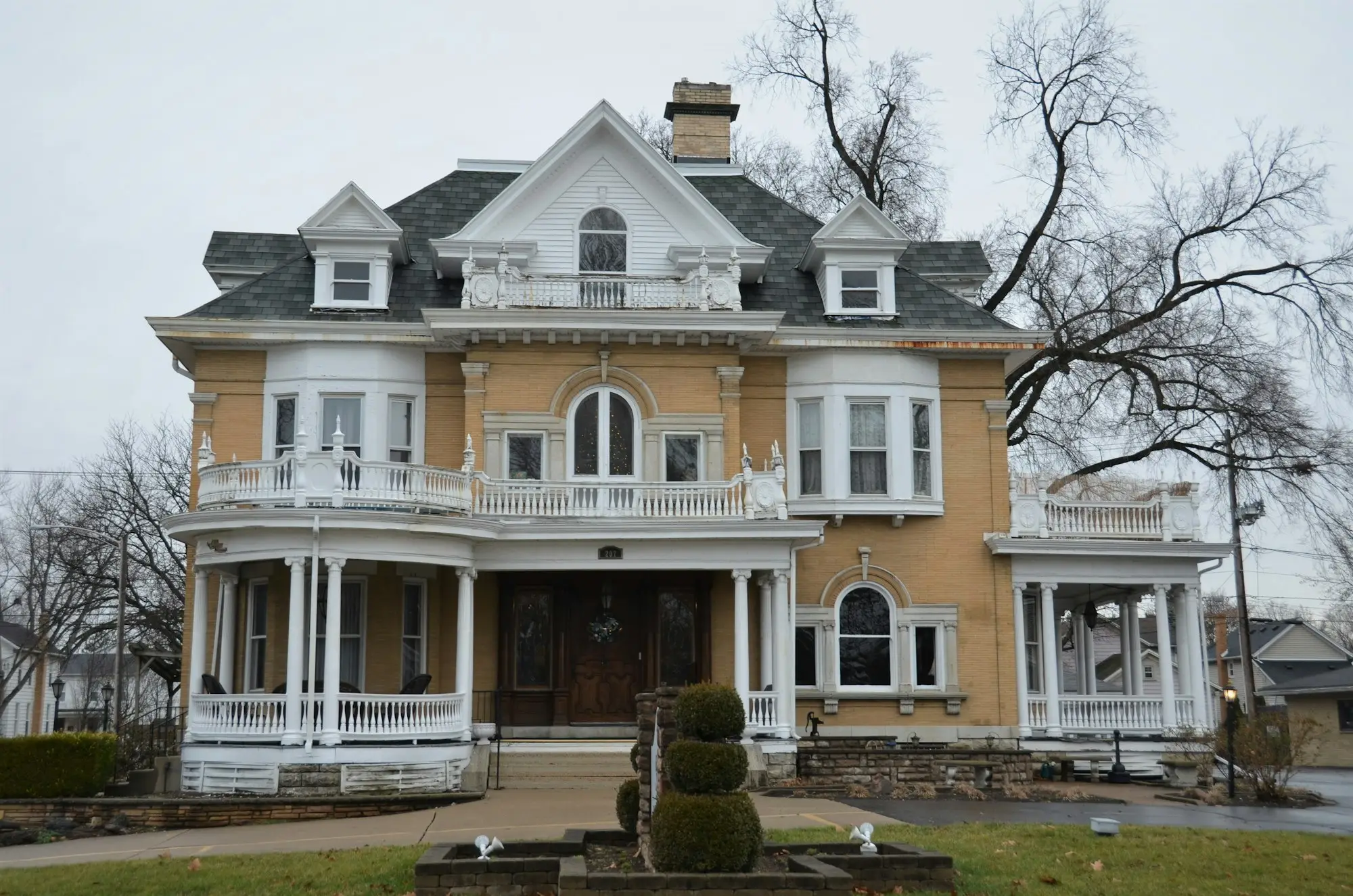 Large yellow house with white trim used as an investment property