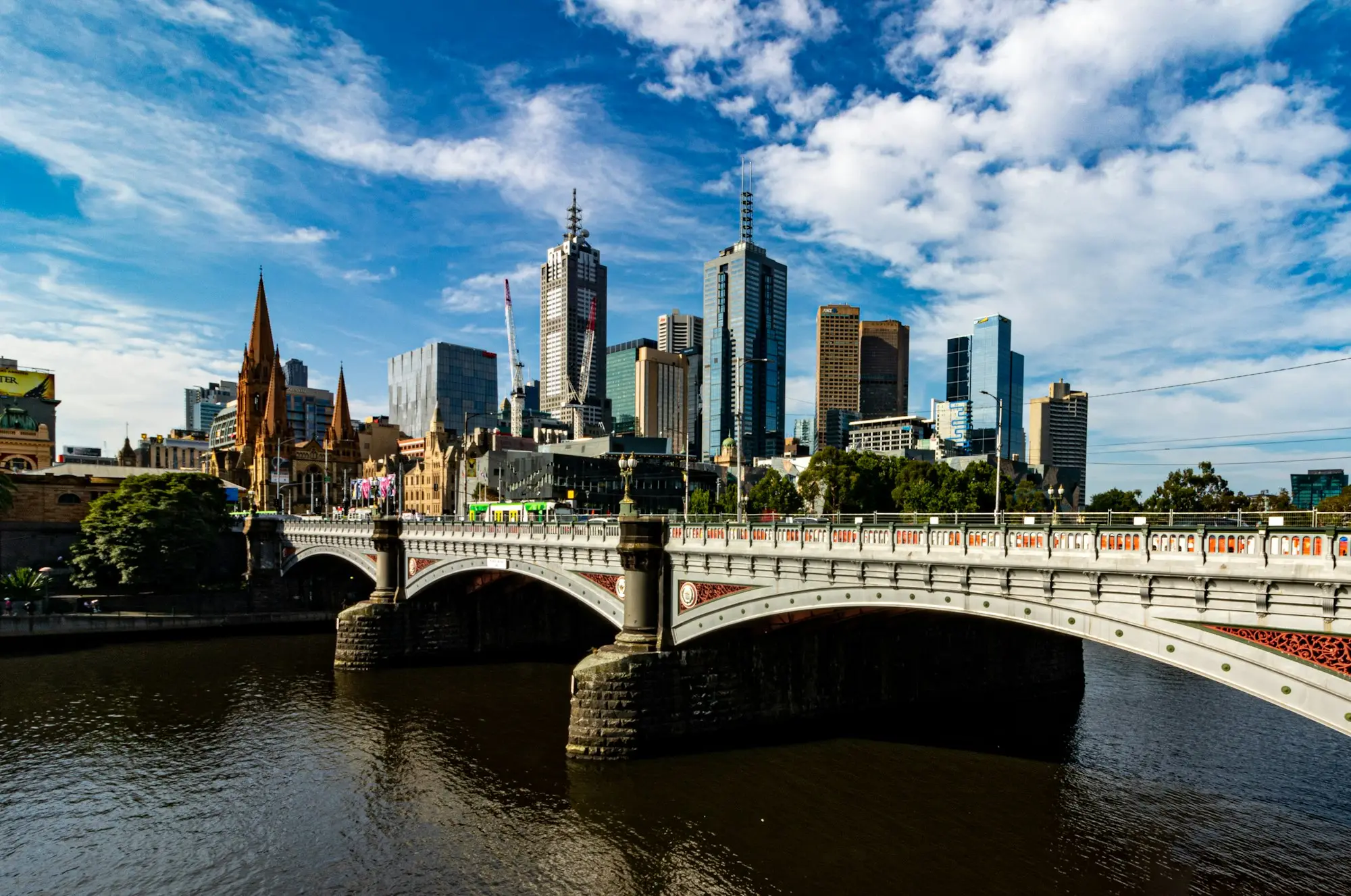 White bridge over the Yarra River near Melbourne city buildings