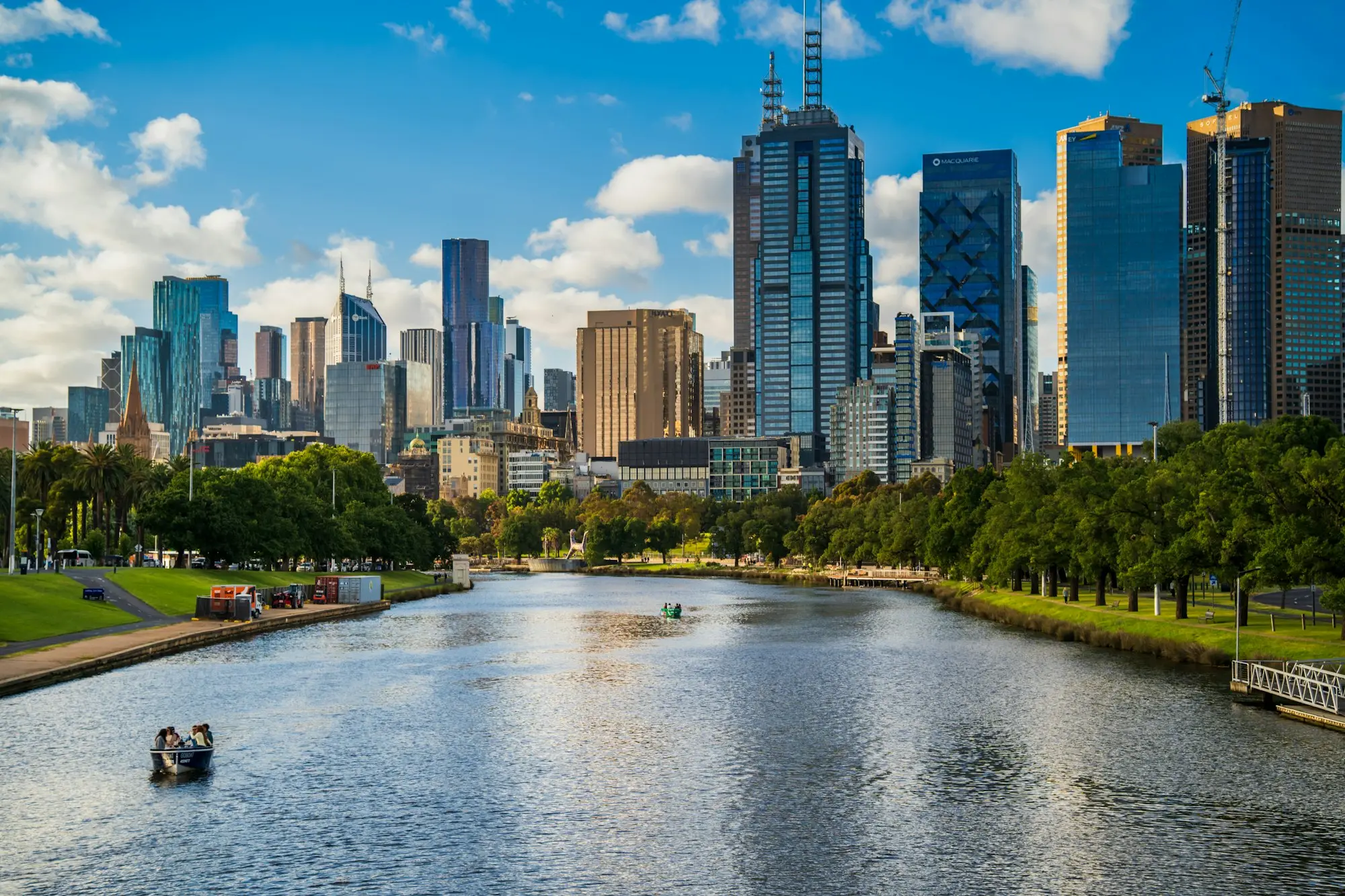 Melbourne city skyline along the Yarra River under blue sky