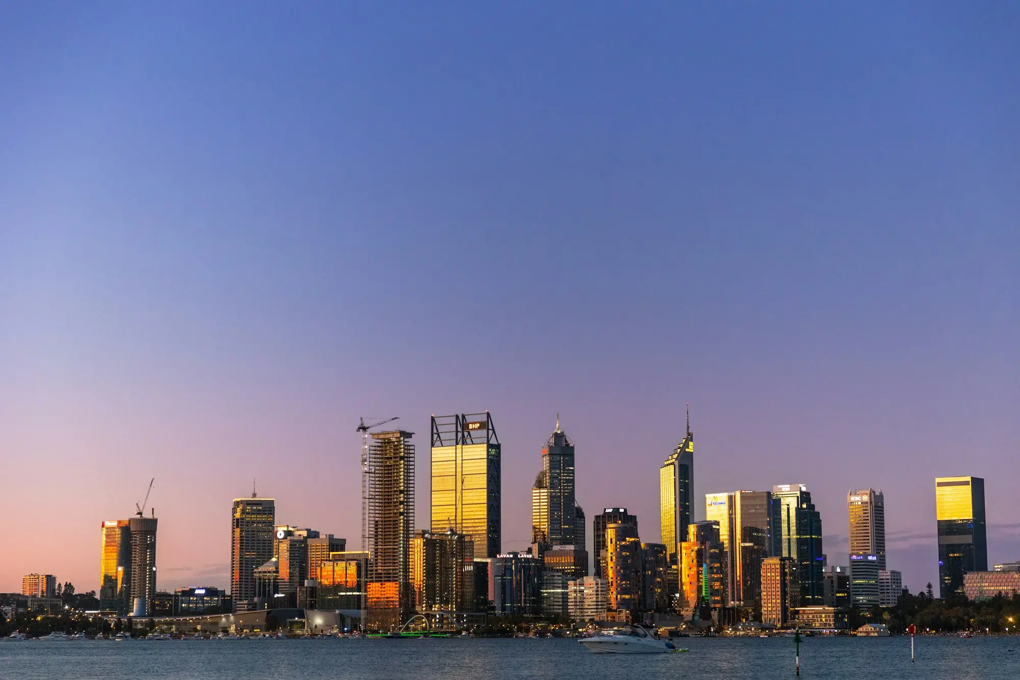 Perth city at dusk seen across the Swan River