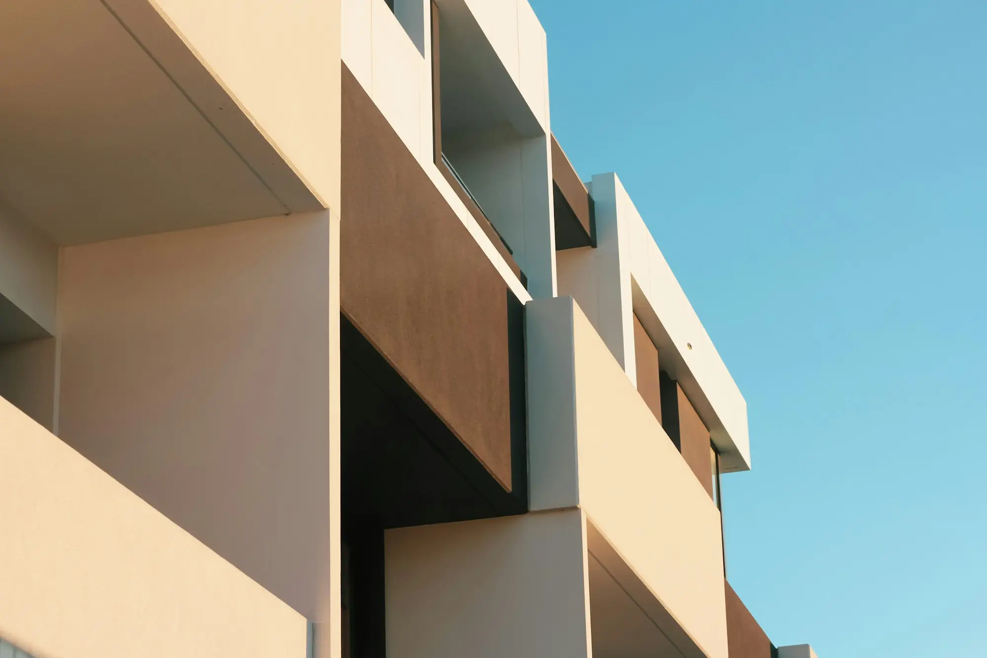 Beige apartment building under a blue sky