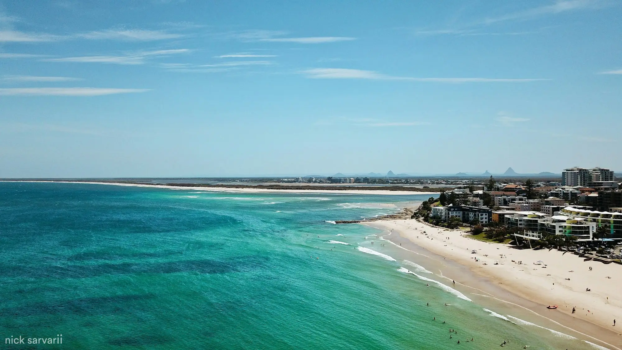Aerial view of a Sunshine Coast beach meeting the ocean