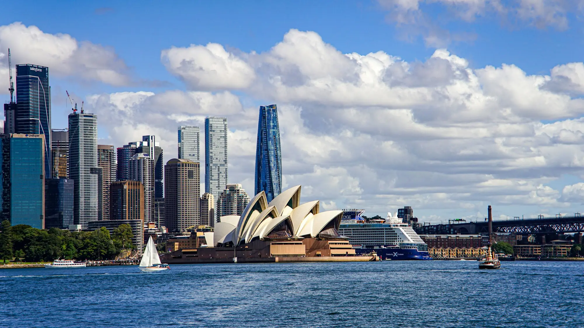 Sydney Opera House and city skyline with sailboats on the harbour