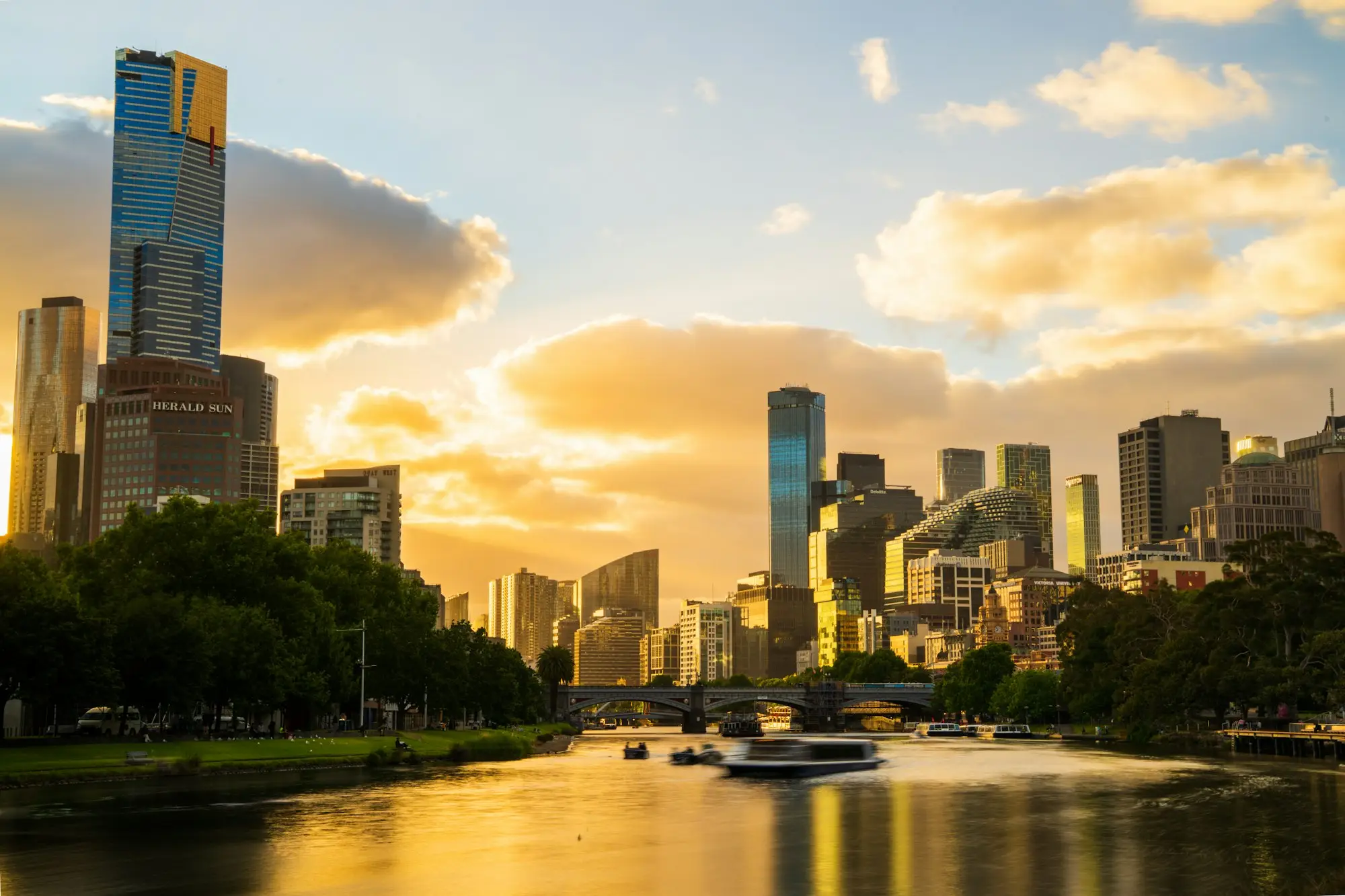 Melbourne skyline at sunset with the river and trees